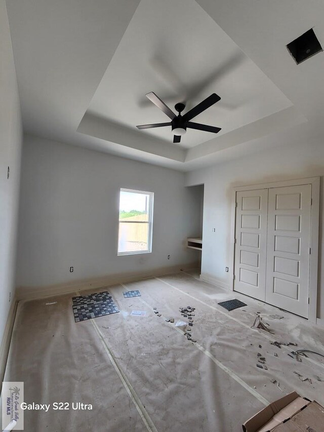 9848 Heights N, Harlingen, TX 78552 - unfurnished bedroom featuring a raised ceiling, baseboards, a closet, and ceiling fan