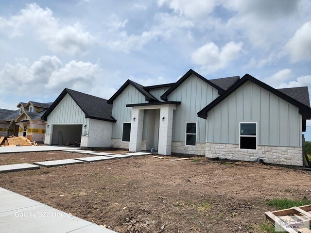9848 Heights N, Harlingen, TX 78552 - modern farmhouse style home featuring board and batten siding, a shingled roof, and a garage