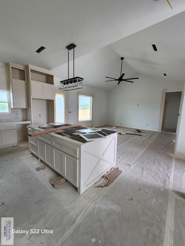 9848 Heights N, Harlingen, TX 78552 - kitchen with lofted ceiling, white cabinets, open floor plan, a kitchen island, and ceiling fan