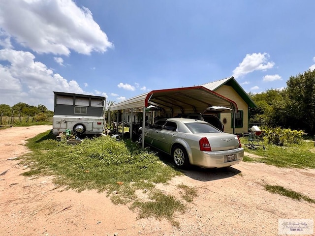 view of vehicle parking with a carport