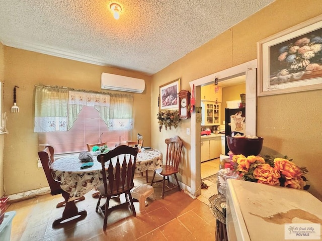 dining room featuring tile patterned flooring, an AC wall unit, and a textured ceiling