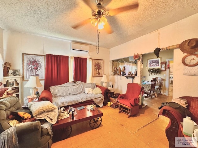 living room with a wall unit AC, ceiling fan, and a textured ceiling