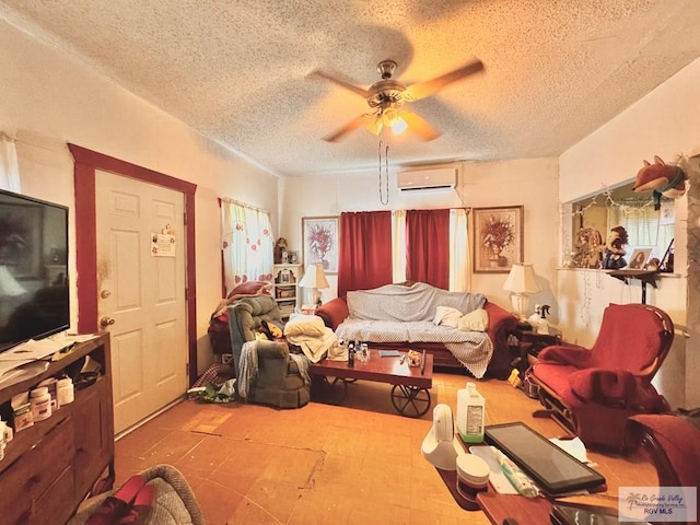 living room with a textured ceiling, a wall unit AC, and ceiling fan