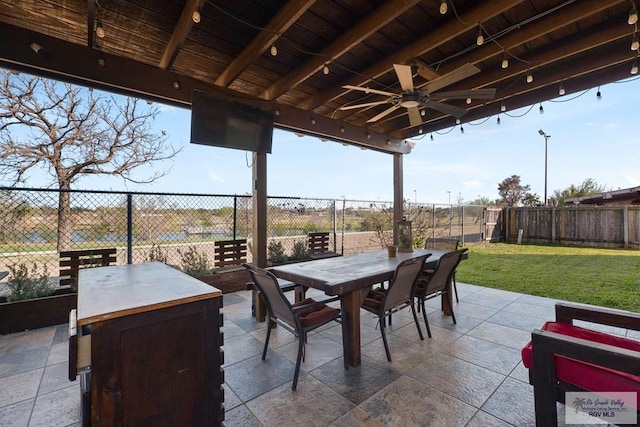 view of patio / terrace featuring outdoor dining space, a fenced backyard, and a ceiling fan