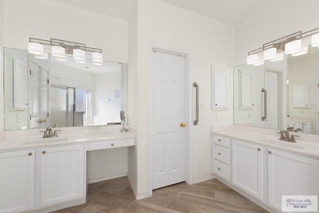 full bathroom with wood finished floors, two vanities, and a sink