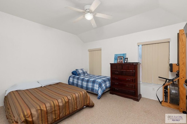 bedroom with a ceiling fan, carpet, and vaulted ceiling