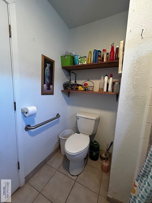 bathroom featuring toilet and tile patterned floors