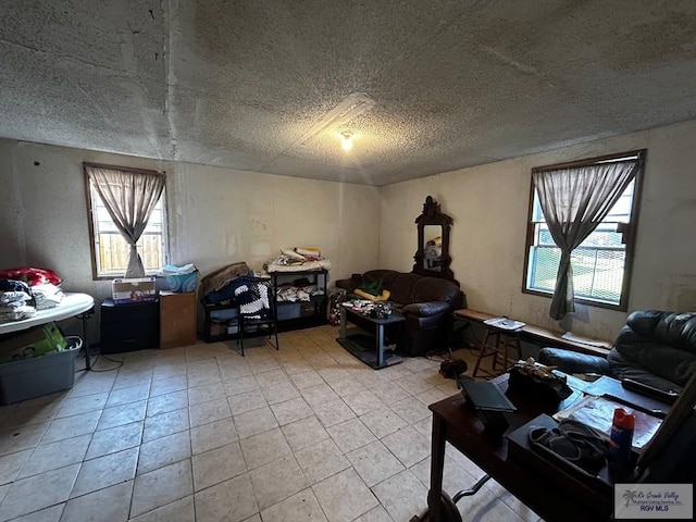 living room featuring a textured ceiling, a healthy amount of sunlight, and light tile patterned flooring