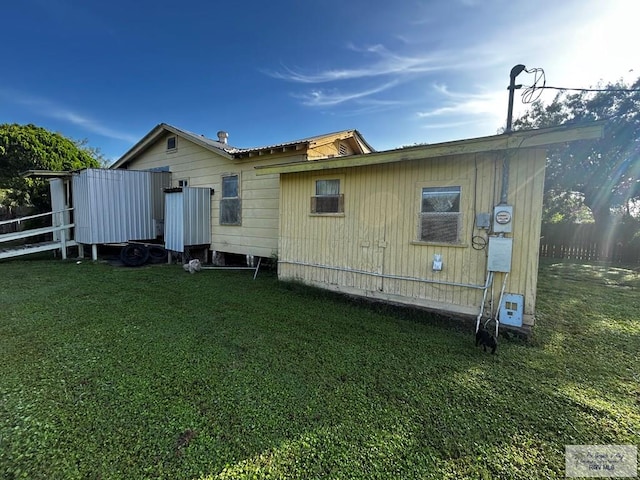 back of property featuring a yard