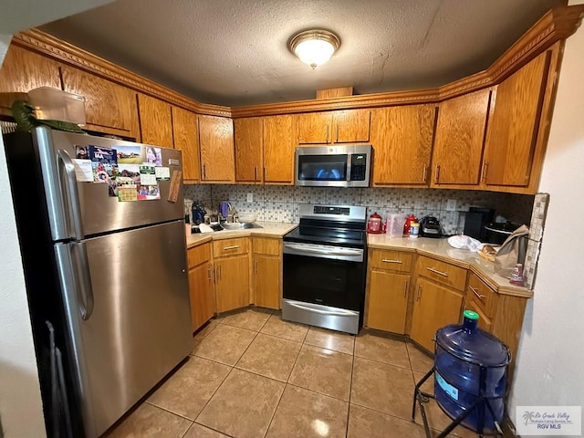 kitchen with light countertops, backsplash, and appliances with stainless steel finishes