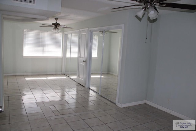 1725 Peach Tree Ct, Harlingen, TX 78550 - empty room featuring a ceiling fan, tile patterned flooring, and baseboards