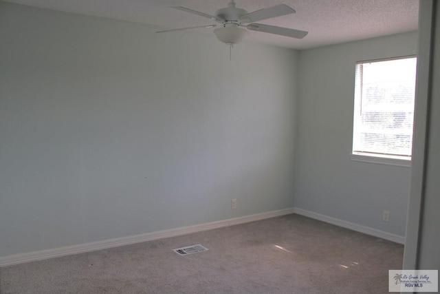 1725 Peach Tree Ct, Harlingen, TX 78550 - unfurnished room with carpet flooring, a ceiling fan, baseboards, and a textured ceiling