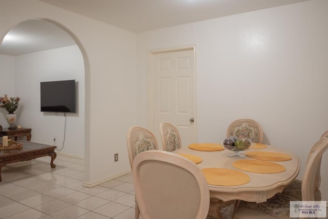 26343 Kansas City Rd Unit 3, La Feria, TX 78559 - dining area with light tile patterned flooring, arched walkways, and baseboards