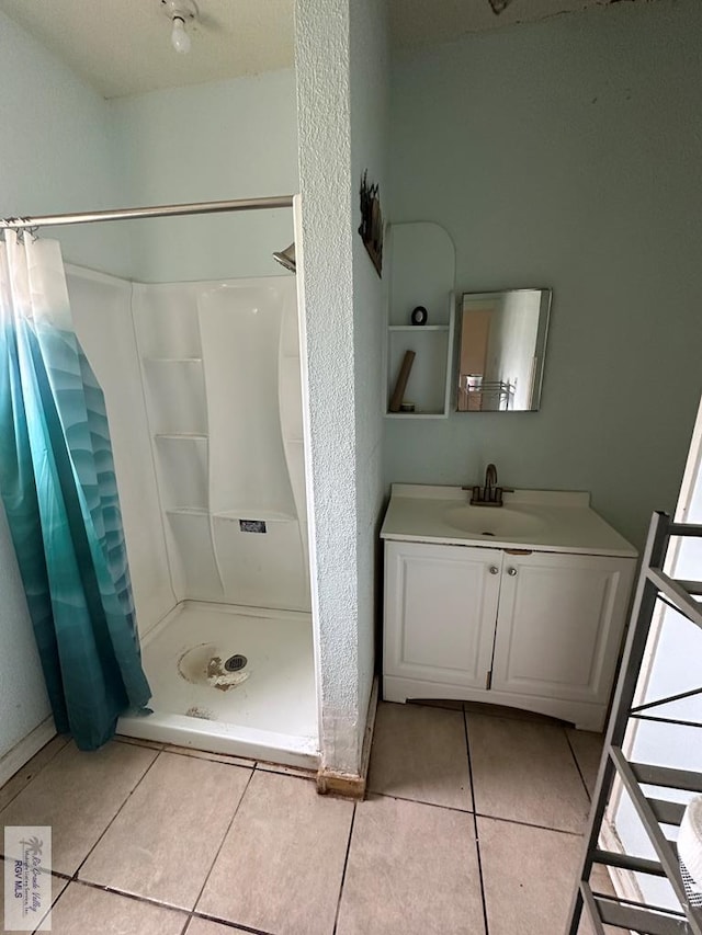 404 Riverside Blvd, Brownsville, TX 78520 - bathroom with tile patterned floors, a shower stall, and vanity