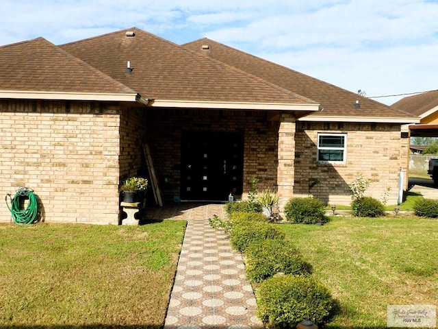 doorway to property with a lawn