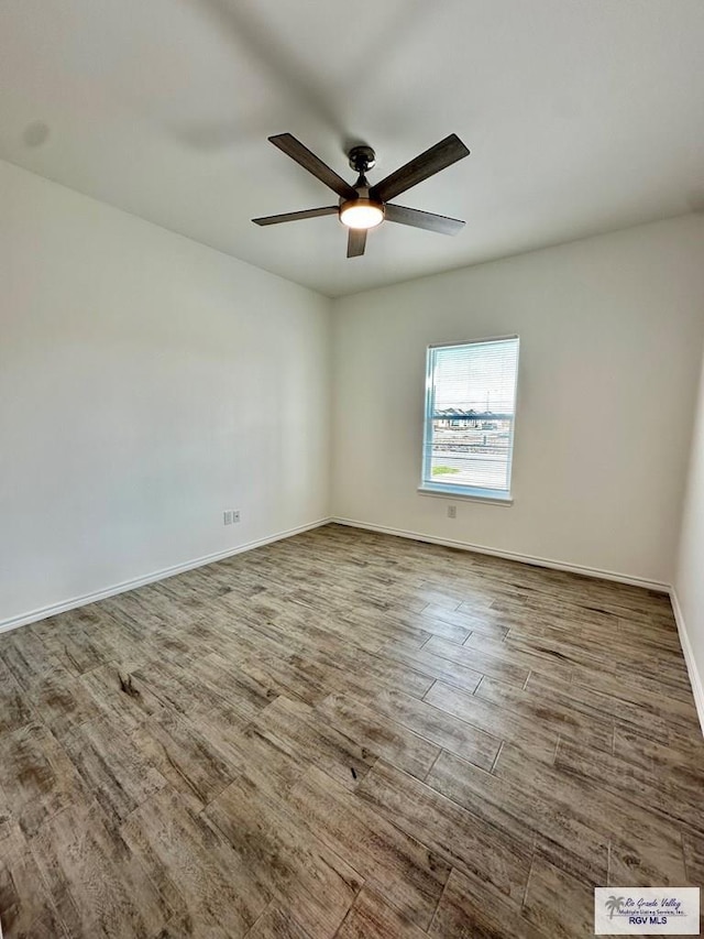 unfurnished room with hardwood / wood-style floors and ceiling fan