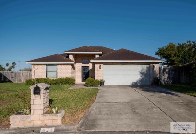 view of front of home featuring a garage, concrete driveway, a front yard, and fence