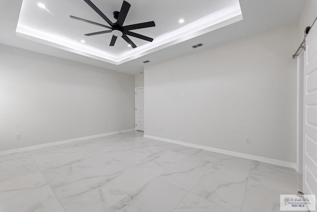 spare room featuring visible vents, ceiling fan, recessed lighting, and a tray ceiling