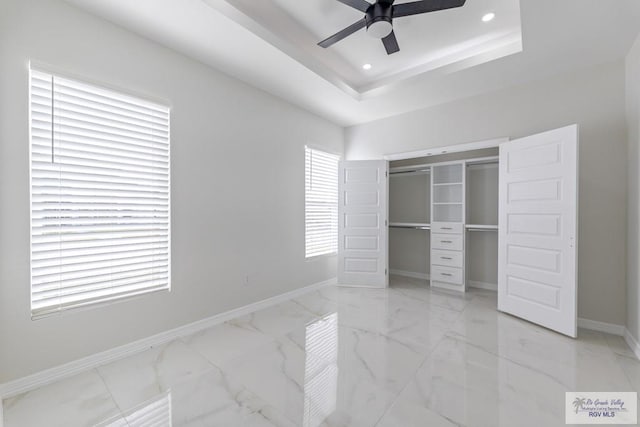 unfurnished bedroom featuring recessed lighting, a closet, marble finish floor, baseboards, and a ceiling fan