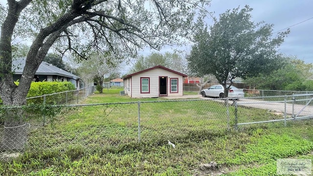 view of property exterior with a lawn and an outdoor structure