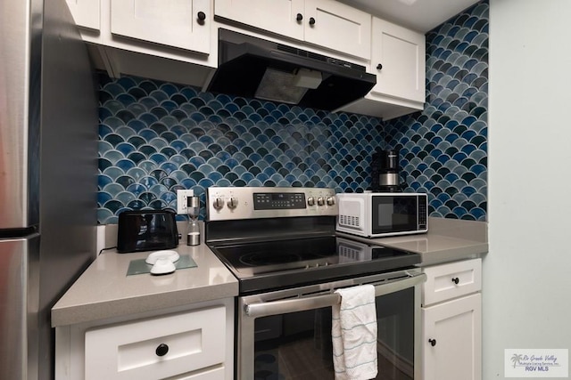 200 Padre Blvd Unit 1206, South Padre Island, TX 78597 - kitchen with appliances with stainless steel finishes, exhaust hood, decorative backsplash, and white cabinets