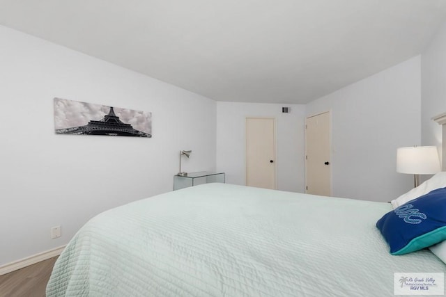 200 Padre Blvd Unit 1206, South Padre Island, TX 78597 - bedroom featuring wood finished floors and baseboards