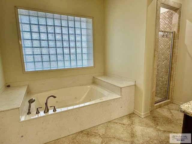 bathroom with separate shower and tub