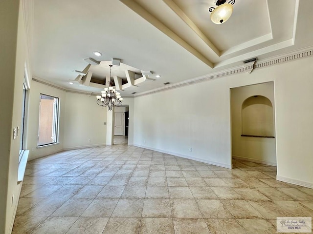 spare room with a raised ceiling, a notable chandelier, and ornamental molding