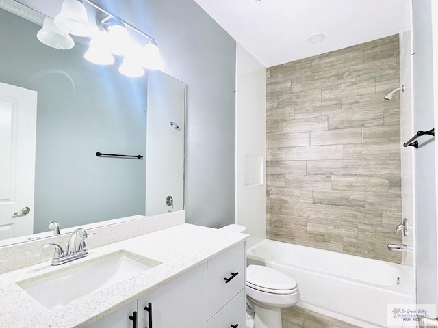 full bathroom with vanity, toilet, and tiled shower / bath combo