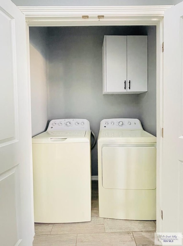 laundry area featuring cabinets and washing machine and dryer