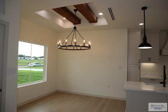 13953 Isaiah Ct, La Feria, TX 78559 - unfurnished dining area with a chandelier, light wood-style floors, recessed lighting, and a raised ceiling