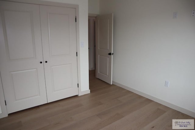13953 Isaiah Ct, La Feria, TX 78559 - unfurnished bedroom with wood finished floors and a closet