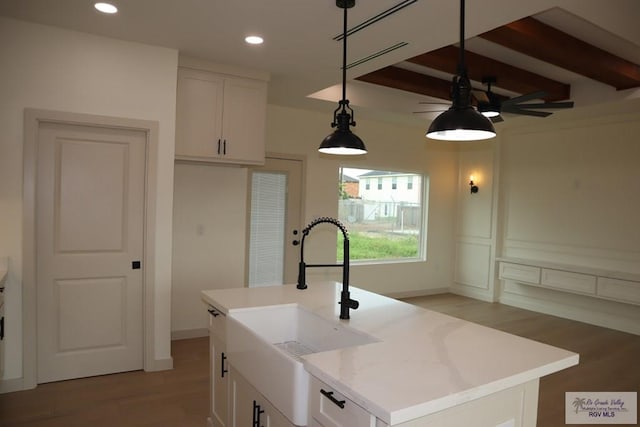 13953 Isaiah Ct, La Feria, TX 78559 - kitchen featuring ceiling fan, light wood-style floors, white cabinetry, beam ceiling, and recessed lighting