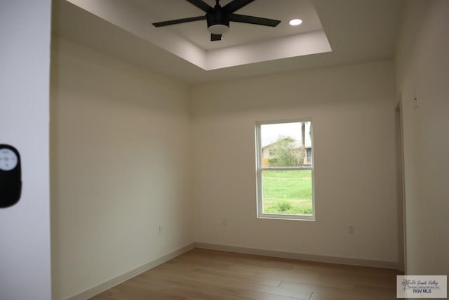 13953 Isaiah Ct, La Feria, TX 78559 - unfurnished room featuring a ceiling fan, light wood-style flooring, a raised ceiling, and recessed lighting