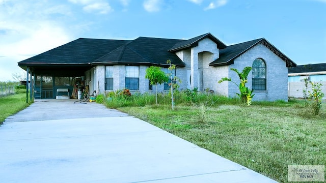 view of front facade with a carport and a front lawn