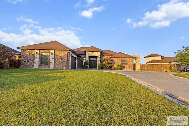 2540 Los Portales Dr, Brownsville, TX 78526 - view of front of property featuring an attached garage, brick siding, and driveway