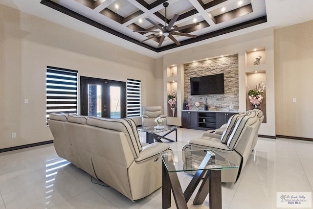 2540 Los Portales Dr, Brownsville, TX 78526 - living area featuring a ceiling fan, a high ceiling, beamed ceiling, coffered ceiling, and light tile patterned floors
