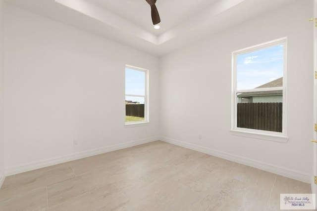 5407 Common Ln, Weslaco, TX 78596 - unfurnished room with a ceiling fan, light wood-type flooring, recessed lighting, and a tray ceiling