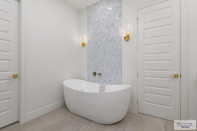 5407 Common Ln, Weslaco, TX 78596 - full bath featuring a freestanding bath and baseboards