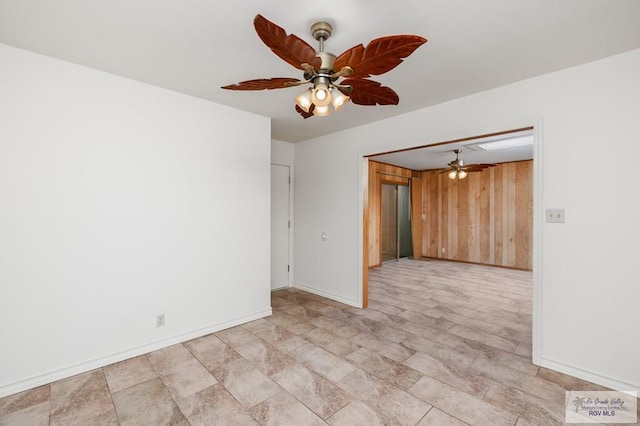 spare room featuring wood walls