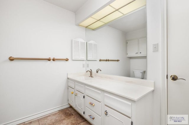 bathroom featuring tile patterned floors, vanity, and toilet