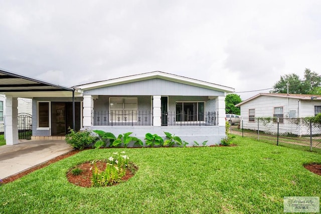 802 California St, Harlingen, TX 78552 - view of front of property featuring fence, covered porch, a front yard, and an attached carport