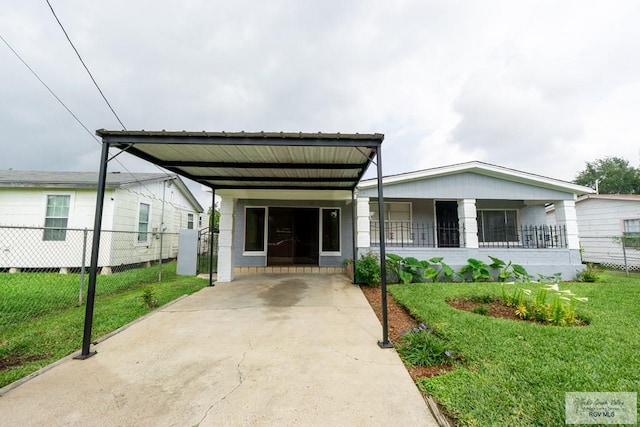 802 California St, Harlingen, TX 78552 - view of front facade featuring fence, a carport, a front yard, and driveway