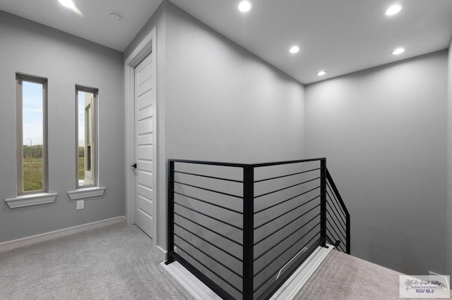 2009 New Combes Rd, Harlingen, TX 78550 - hall with an upstairs landing, recessed lighting, carpet, and baseboards
