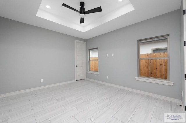 2009 New Combes Rd, Harlingen, TX 78550 - spare room with a ceiling fan, a raised ceiling, baseboards, and recessed lighting