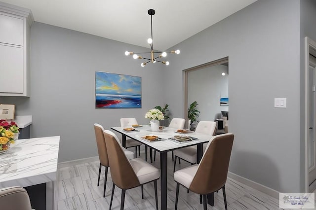 2009 New Combes Rd, Harlingen, TX 78550 - dining space featuring a chandelier, vaulted ceiling, baseboards, and light marble finish flooring