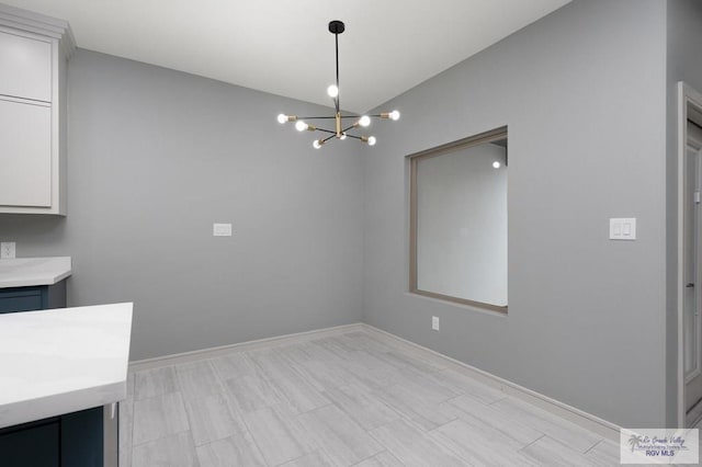 2009 New Combes Rd, Harlingen, TX 78550 - unfurnished dining area with a chandelier, lofted ceiling, and baseboards