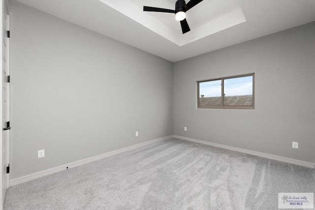 2009 New Combes Rd, Harlingen, TX 78550 - carpeted empty room featuring ceiling fan, baseboards, and a raised ceiling