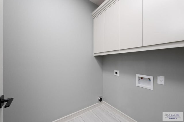2009 New Combes Rd, Harlingen, TX 78550 - laundry area with cabinet space, hookup for an electric dryer, hookup for a washing machine, and baseboards