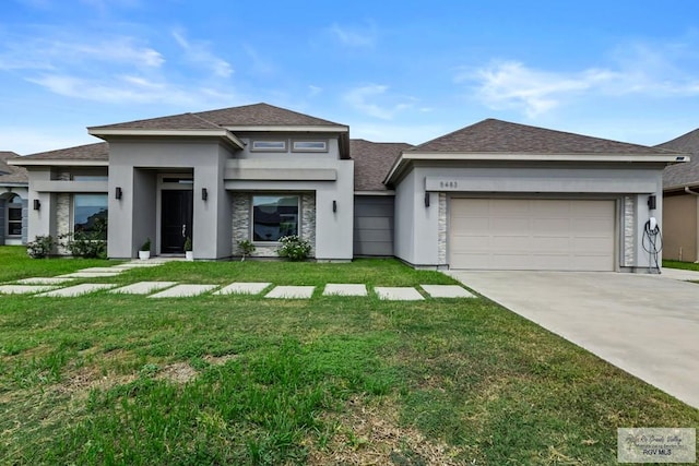 5483 Lovers Ln, Brownsville, TX 78526 - prairie-style house with roof with shingles, an attached garage, a front yard, and stucco siding